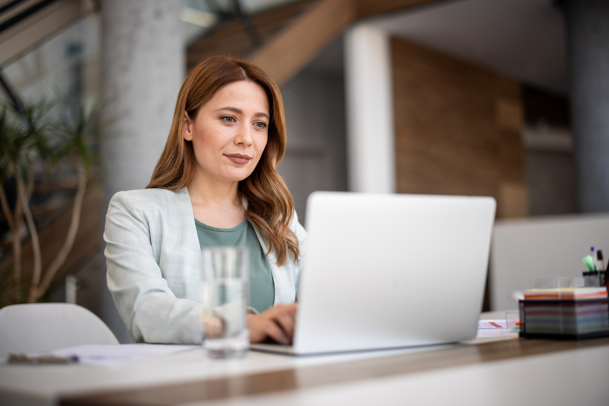 Successful businesswoman using laptop, working in office. Business technology corporate concept